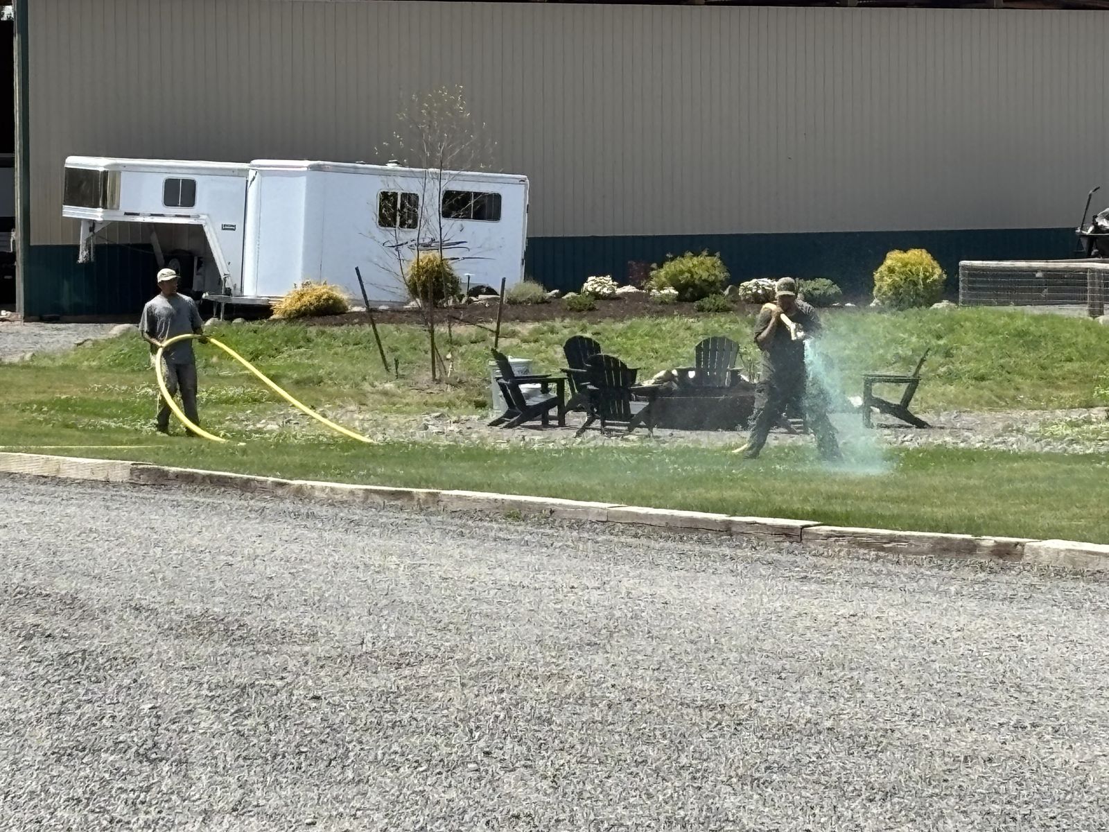Two individuals working outside on a grassy area
