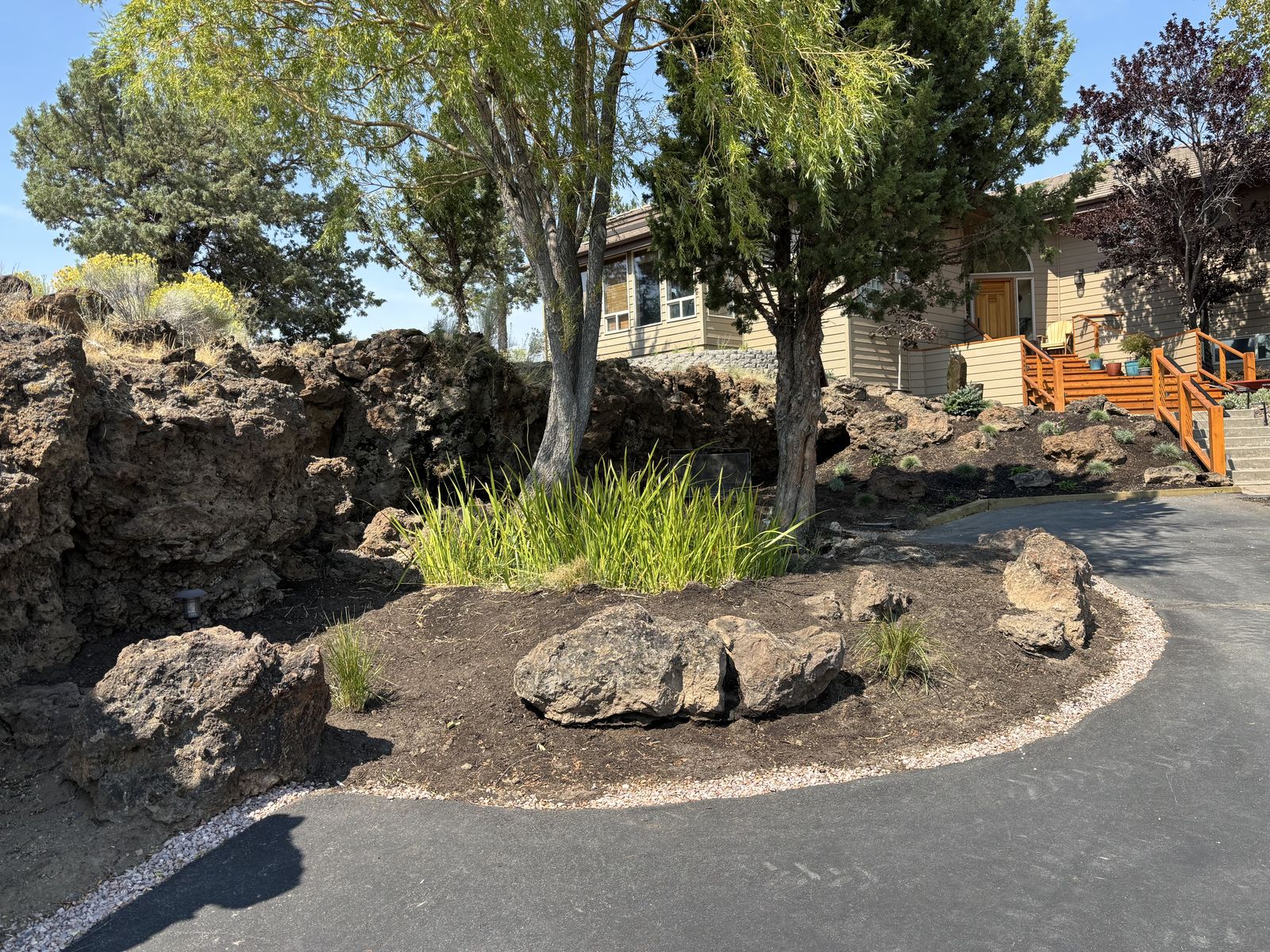 Lush landscaping featuring green grass and rocks