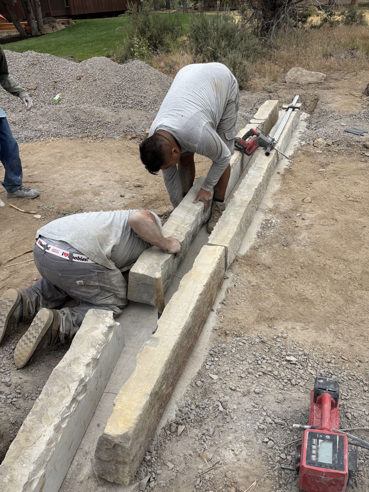 Installing a custom natural stone inlayed double band crib in driveway