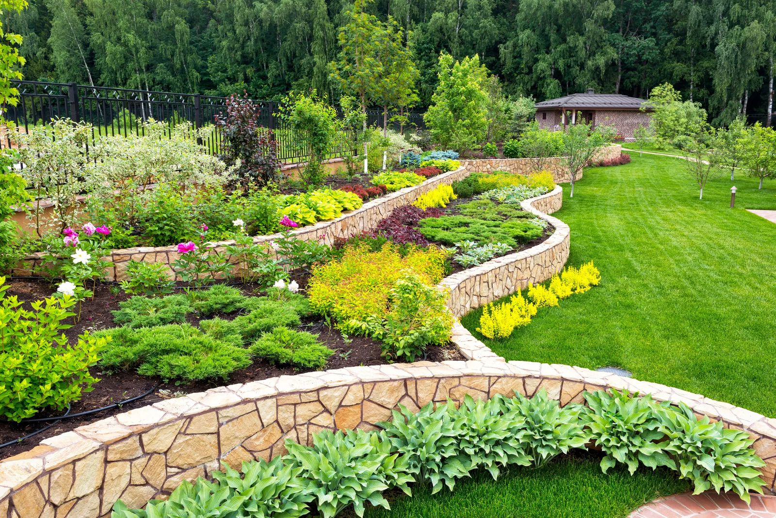 Lush garden featuring curved stone borders